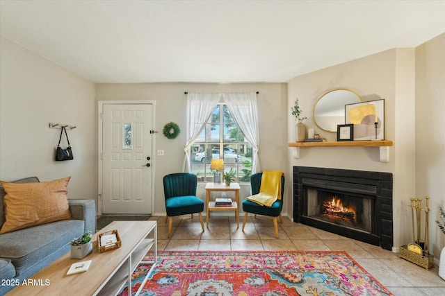 living area with tile patterned floors and a lit fireplace