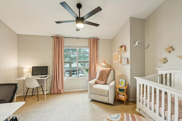 bedroom featuring baseboards, lofted ceiling, ceiling fan, a crib, and carpet flooring