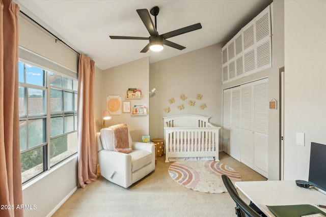 bedroom featuring a closet, light colored carpet, and ceiling fan