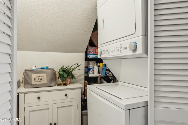 laundry room with laundry area, stacked washer and dryer, and a textured wall