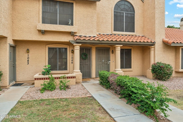 view of front of home with stucco siding and a tile roof