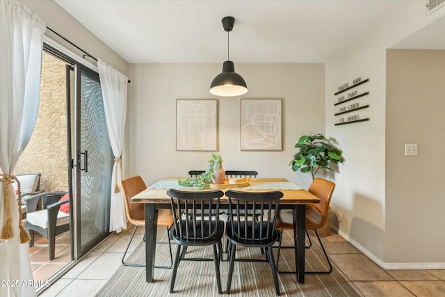 dining room with visible vents, baseboards, and light tile patterned flooring