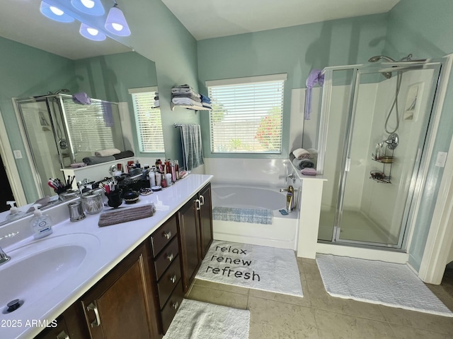 full bathroom featuring tile patterned floors, a garden tub, vanity, and a stall shower