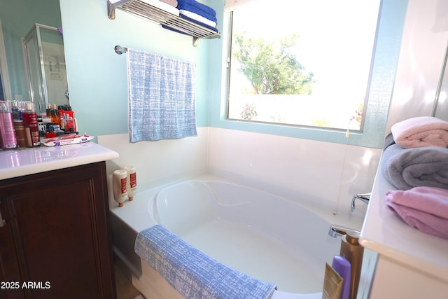 full bath with a garden tub and vanity