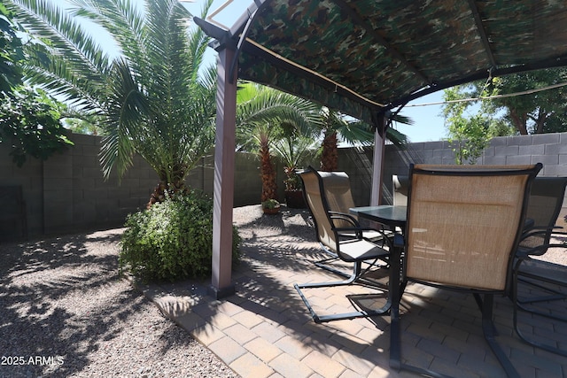 view of patio featuring a pergola, a fenced backyard, and outdoor dining area