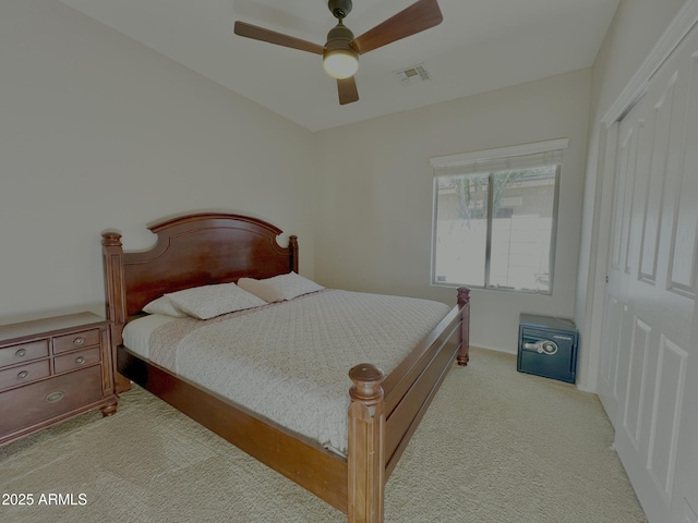 bedroom featuring ceiling fan, a closet, visible vents, and carpet