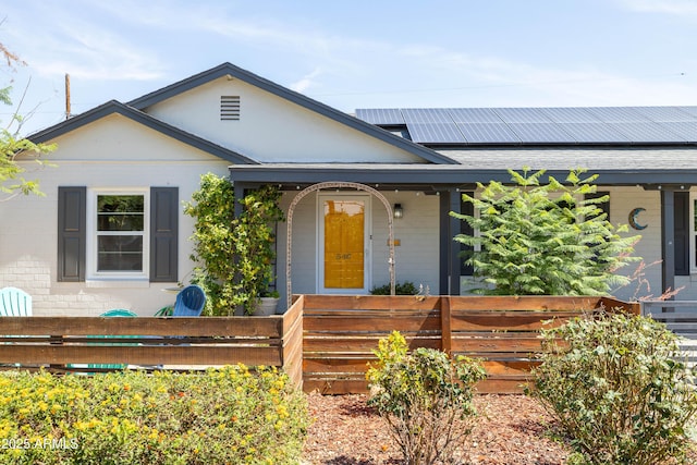 546 W Cambridge Ave, Phoenix, AZ 85003 - view of front of property featuring a porch, solar panels, and brick siding