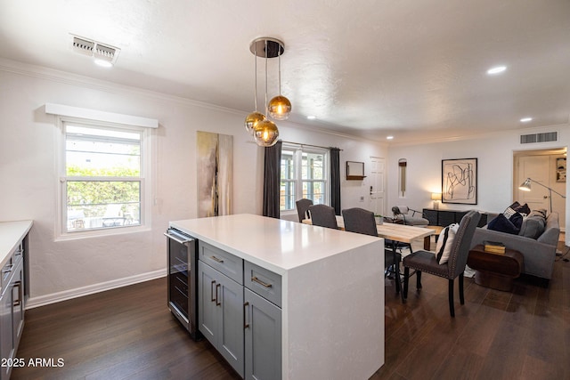 546 W Cambridge Ave, Phoenix, AZ 85003 - kitchen featuring gray cabinets, open floor plan, beverage cooler, dark wood-type flooring, and crown molding