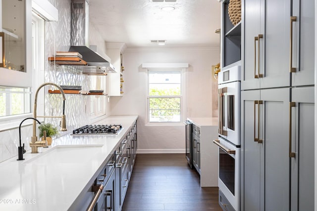 546 W Cambridge Ave, Phoenix, AZ 85003 - kitchen featuring open shelves, wall chimney exhaust hood, baseboards, stainless steel gas stovetop, and light countertops