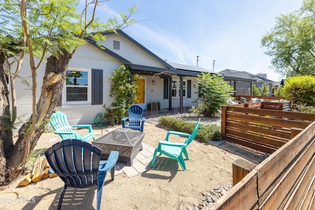 546 W Cambridge Ave, Phoenix, AZ 85003 - back of property featuring roof mounted solar panels, an outdoor fire pit, and concrete block siding
