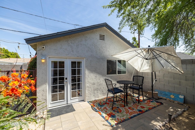 546 W Cambridge Ave, Phoenix, AZ 85003 - back of house with french doors, a patio, stucco siding, and outdoor dining space
