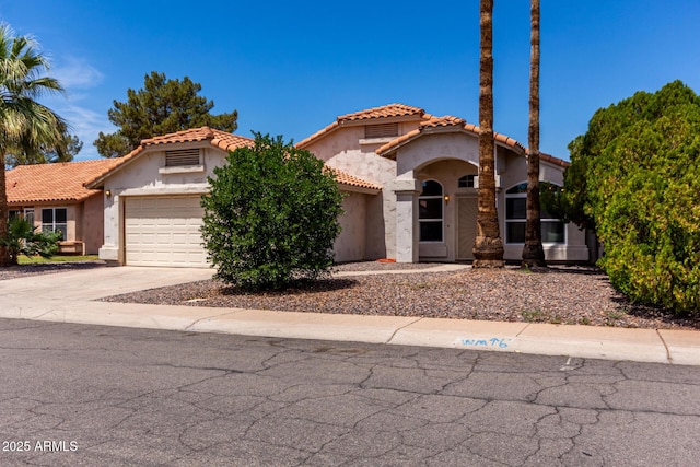626 W Catclaw St, Gilbert, AZ 85233 - mediterranean / spanish home with a garage, stucco siding, a tiled roof, and concrete driveway