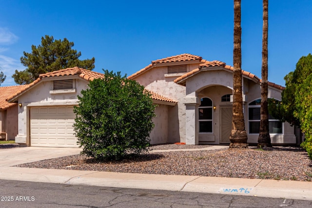 626 W Catclaw St, Gilbert, AZ 85233 - mediterranean / spanish house featuring concrete driveway, an attached garage, a tile roof, and stucco siding