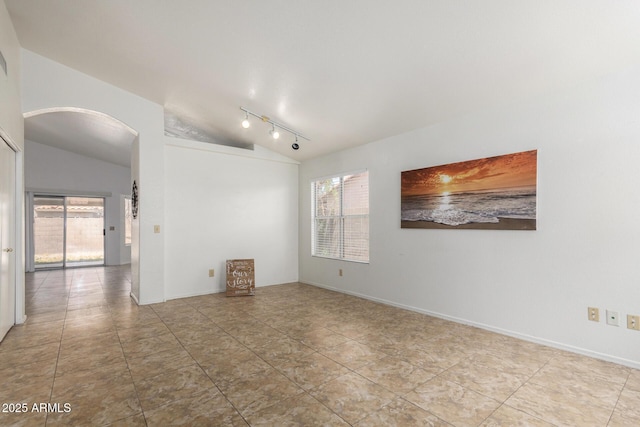 626 W Catclaw St, Gilbert, AZ 85233 - tiled spare room featuring arched walkways, track lighting, and lofted ceiling