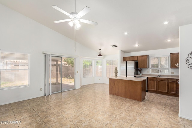 626 W Catclaw St, Gilbert, AZ 85233 - kitchen with a sink, light countertops, freestanding refrigerator, a kitchen island, and visible vents