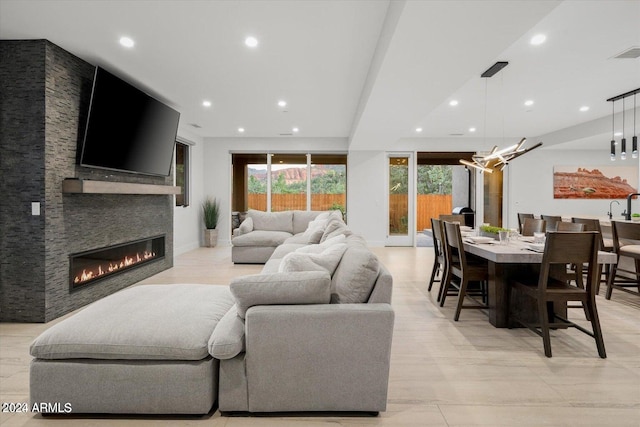 living room with a stone fireplace and a healthy amount of sunlight