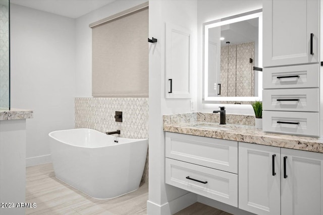 bathroom featuring vanity, backsplash, and separate shower and tub