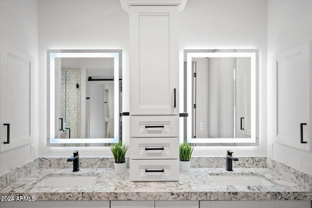 bathroom with a shower with door and vanity