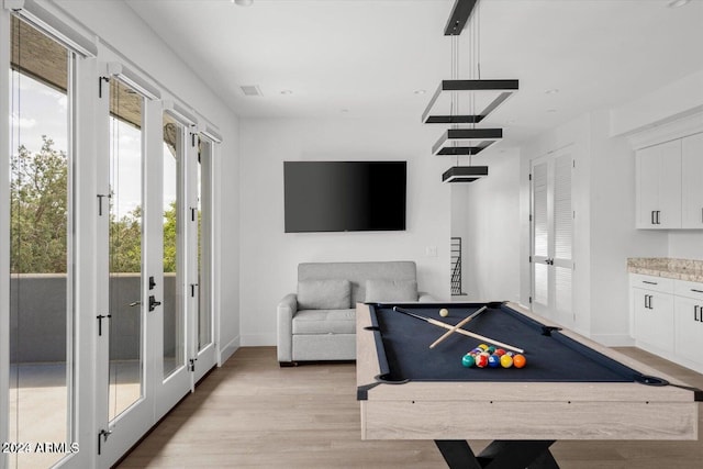 playroom featuring billiards, light hardwood / wood-style flooring, and french doors