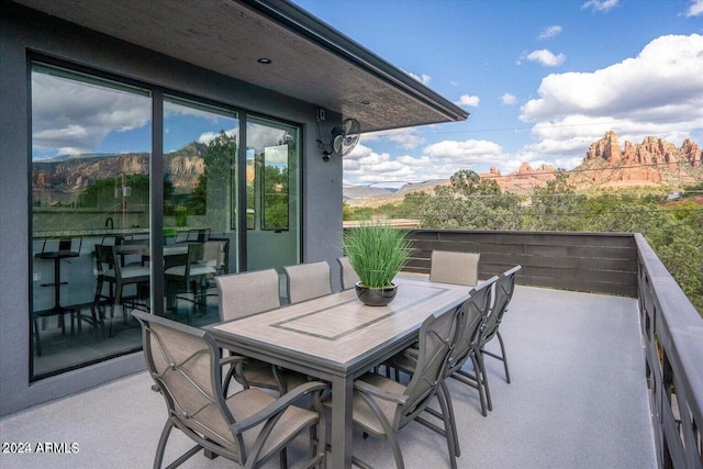 view of patio featuring a mountain view and a balcony