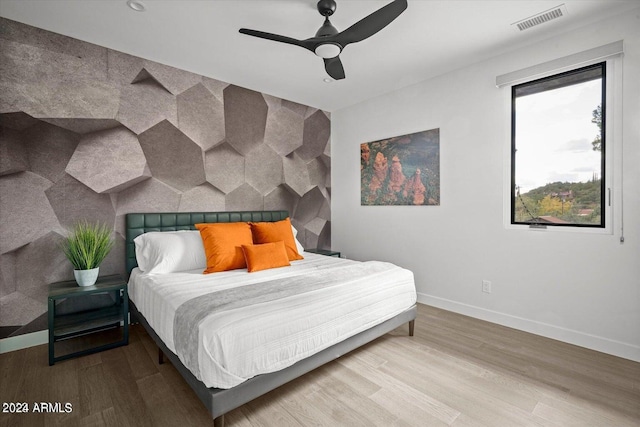 bedroom with hardwood / wood-style floors and ceiling fan