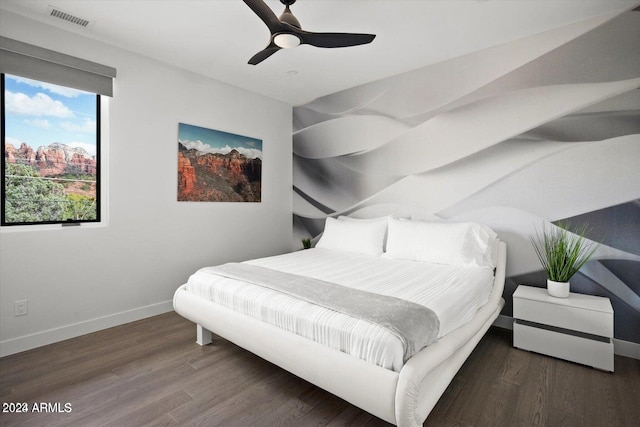 bedroom with ceiling fan and dark hardwood / wood-style floors