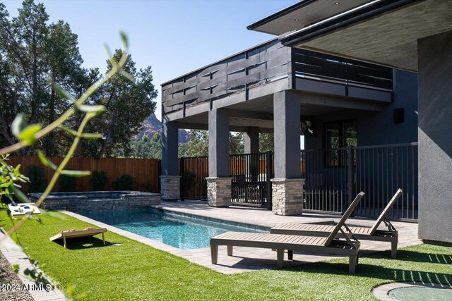 view of pool with a yard and a patio