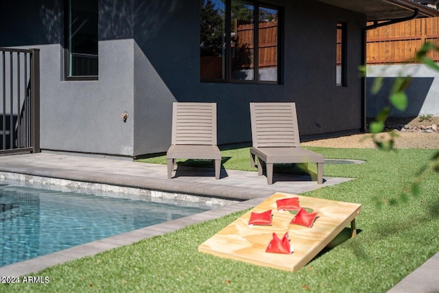 view of pool featuring a yard and a patio area