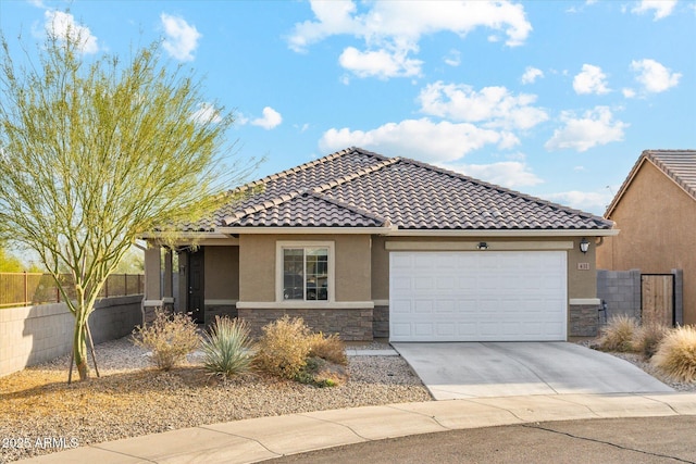 view of front of house featuring a tile roof, stucco siding, a garage, stone siding, and driveway