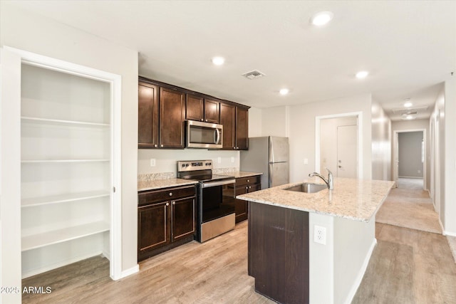431 W Guinea Ct, Casa Grande, AZ 85122 - kitchen with stainless steel appliances, a sink, visible vents, light stone countertops, and an island with sink