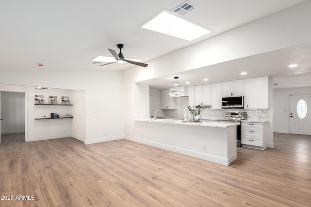 4310 E Sacaton St, Phoenix, AZ 85044 - kitchen with light countertops, stainless steel appliances, visible vents, and light wood-style floors