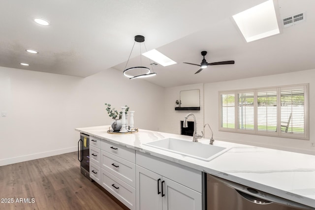4310 E Sacaton St, Phoenix, AZ 85044 - kitchen featuring a sink, wood finished floors, stainless steel dishwasher, a skylight, and visible vents