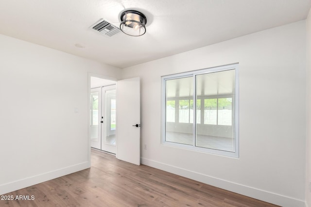 4310 E Sacaton St, Phoenix, AZ 85044 - unfurnished room with visible vents, baseboards, and wood finished floors