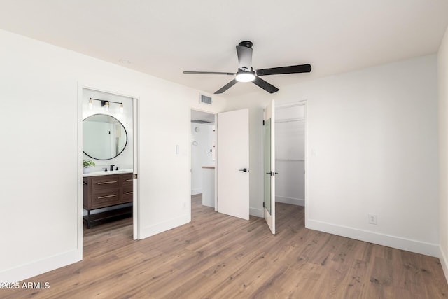 4310 E Sacaton St, Phoenix, AZ 85044 - unfurnished bedroom with visible vents, baseboards, and light wood-style floors