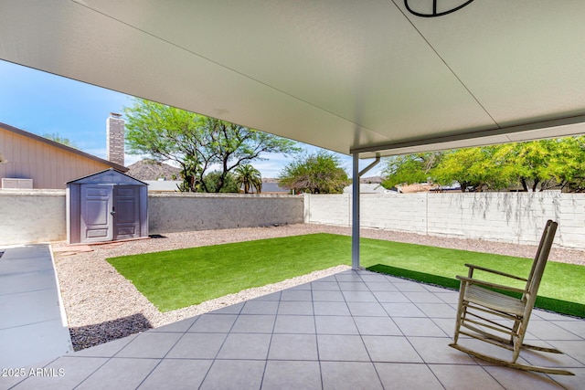 4310 E Sacaton St, Phoenix, AZ 85044 - view of patio / terrace with an outdoor structure, a fenced backyard, and a storage unit