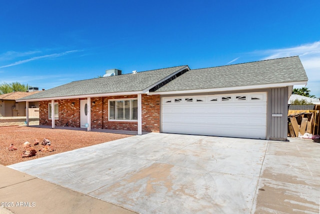 4310 E Sacaton St, Phoenix, AZ 85044 - ranch-style home featuring a garage, a shingled roof, concrete driveway, and brick siding