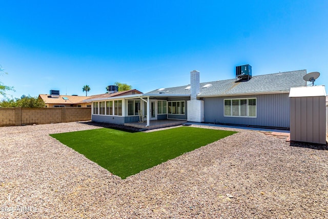 4310 E Sacaton St, Phoenix, AZ 85044 - rear view of house with fence private yard, a chimney, a patio area, central air condition unit, and a yard
