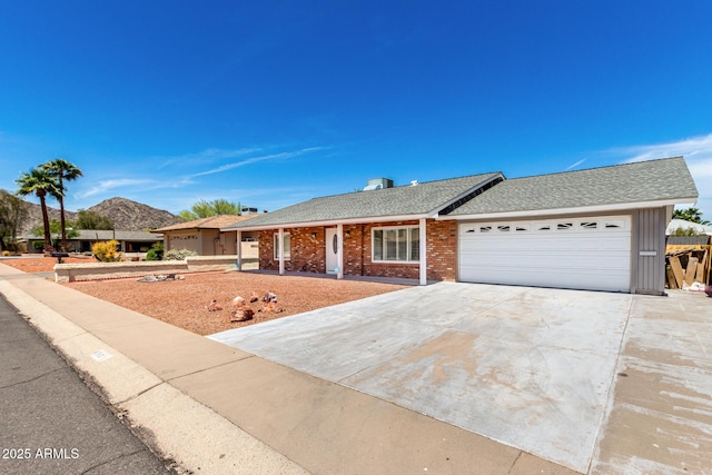 4310 E Sacaton St, Phoenix, AZ 85044 - ranch-style house featuring an attached garage, roof with shingles, driveway, and brick siding