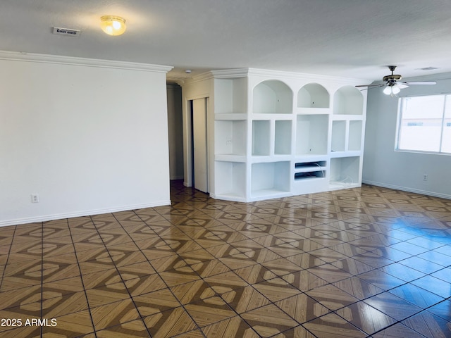 spare room with a ceiling fan, baseboards, and ornamental molding