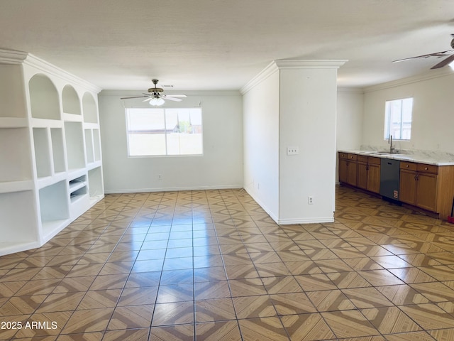 spare room with ceiling fan, ornamental molding, a sink, and baseboards