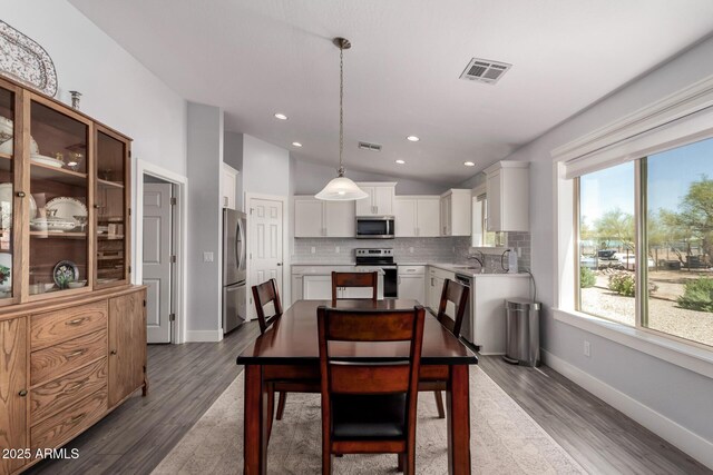 32431 N 226th Ave, Wittmann, AZ 85361 - dining space with vaulted ceiling, dark wood-type flooring, baseboards, and recessed lighting