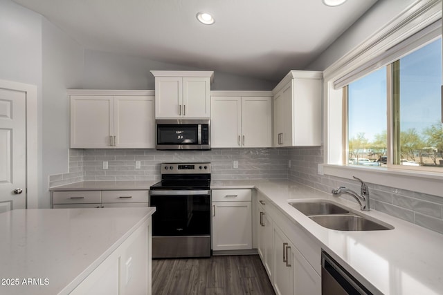 32431 N 226th Ave, Wittmann, AZ 85361 - kitchen with appliances with stainless steel finishes, a sink, vaulted ceiling, white cabinetry, and dark wood-type flooring