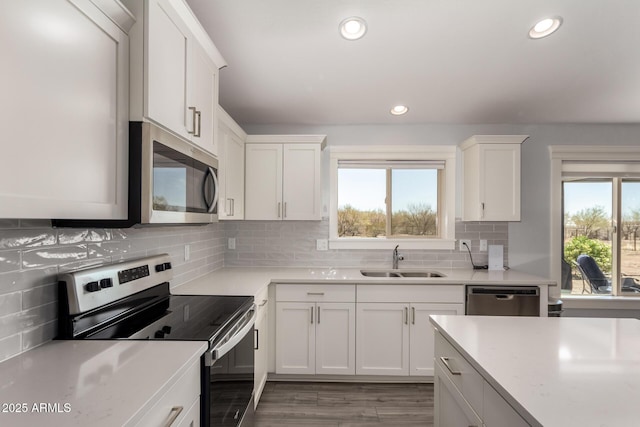 32431 N 226th Ave, Wittmann, AZ 85361 - kitchen with stainless steel appliances, a sink, light countertops, white cabinets, and recessed lighting