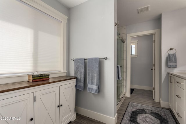 32431 N 226th Ave, Wittmann, AZ 85361 - bathroom featuring a shower stall, baseboards, and wood finished floors