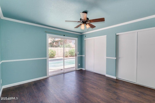 4330 E Desert Trumpet Rd, Phoenix, AZ 85044 - unfurnished bedroom with two closets, access to exterior, wood finished floors, ornamental molding, and baseboards