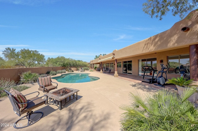 view of pool featuring a patio area and an outdoor fire pit