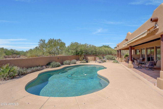 view of swimming pool with a patio area