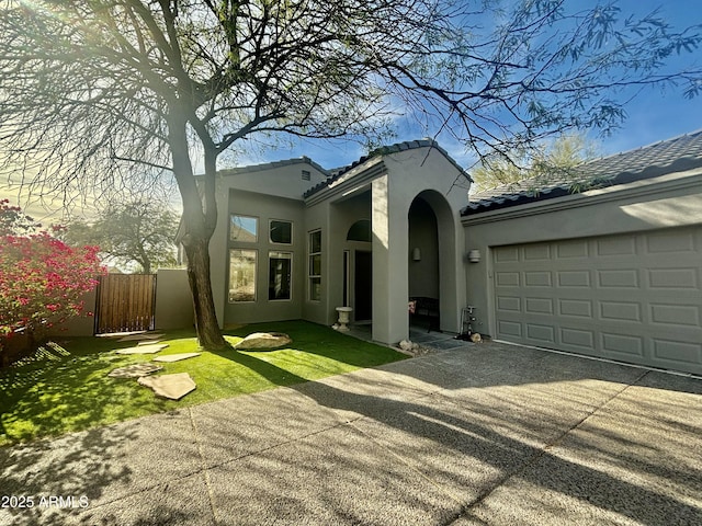 view of front facade with a garage and a front lawn