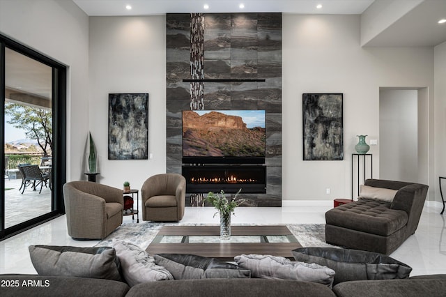 living room featuring a tiled fireplace