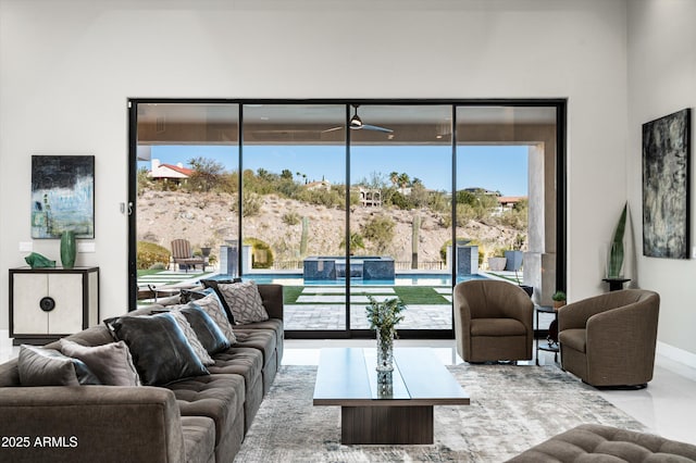 living room featuring a healthy amount of sunlight and ceiling fan